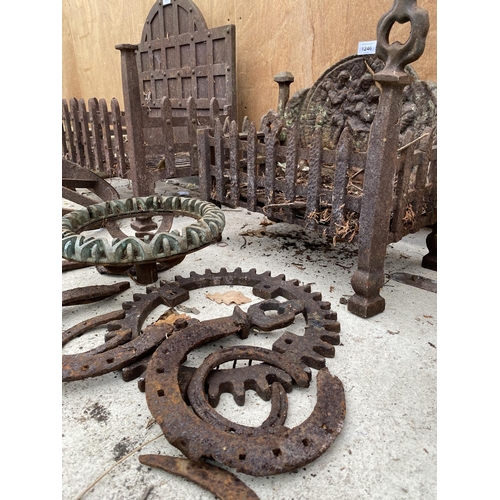 1246 - A COLLECTION OF VINTAGE CAST ITEMS TO INCLUDE HORSE SHOES, COGS AND A FIRE GRATE