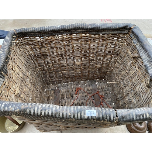 1287 - A LARGE VINTAGE WICKER LAUNDRY TROLLEY ON METAL WHEELS