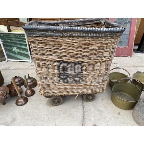 1287 - A LARGE VINTAGE WICKER LAUNDRY TROLLEY ON METAL WHEELS