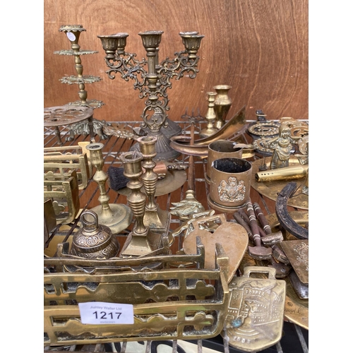 1217 - A LARGE COLLECTION OF BRASS ITEMS TO INCLUDE CANDLESTICKS, HORSE BRASSES AND TRIVET STAND ETC