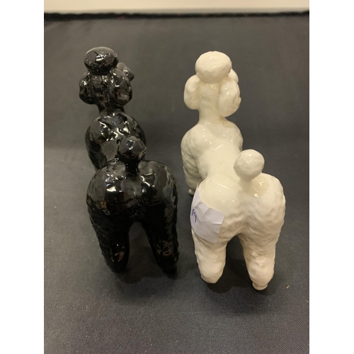 705 - TWO BESWICK POODLE DOGS ONE BLACK ONE WHITE