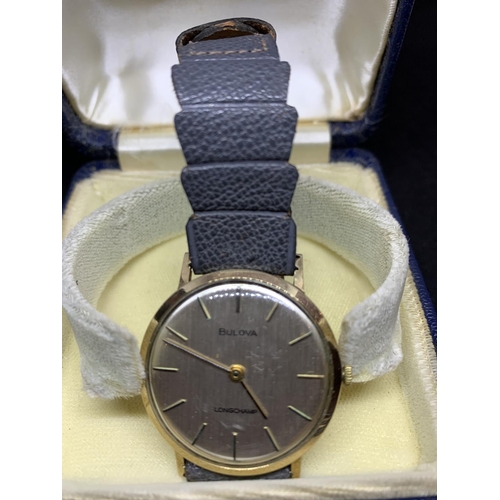 583 - A BULOVA LONGCHAMP 9 CARAT GOLD WRISTWATCH ENGRAVED IN WORKING ORDER WITH PRESENTATION BOX