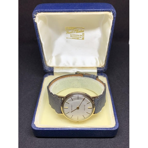 583 - A BULOVA LONGCHAMP 9 CARAT GOLD WRISTWATCH ENGRAVED IN WORKING ORDER WITH PRESENTATION BOX