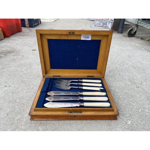 1336 - A SILVER PLATE CANTEEN OF FISH CUTLERY IN A WALNUT DISPLAY BOX