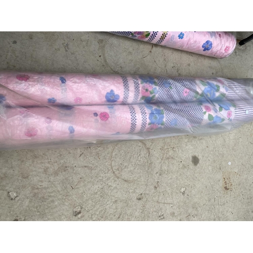 1355 - THREE ROLLS OF PINK AND FLORAL MATERIAL