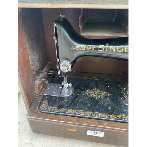 1411 - A VINTAGE SINGER SEWING MACHINE IN A CARRY CASE