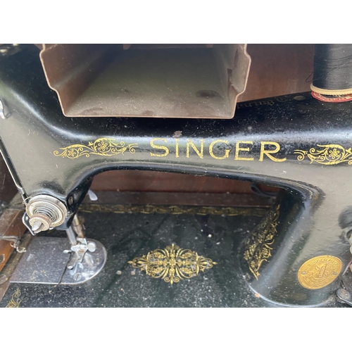 1411 - A VINTAGE SINGER SEWING MACHINE IN A CARRY CASE