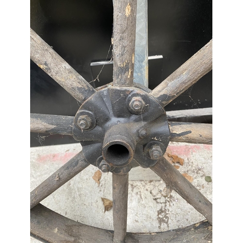 1464 - A VINTAGE WOODEN CART WHEEL WITH METAL OUTER BAND