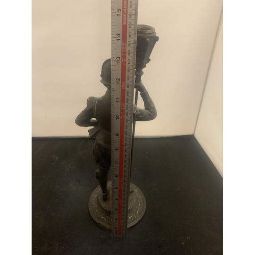 21 - A VINTAGE SPELTER CANDLESTICK IN THE FORM OF A HISTORICAL FIGURINE