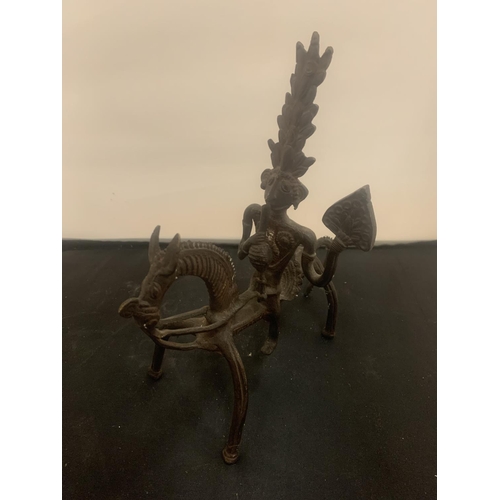 22 - A VINTAGE CAST ORNAMENT IN THE ABSTRACT FORM OF A SOUTH AMERICAN STYLE HORSE AND RIDER