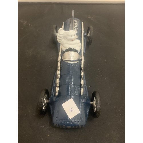 32 - A VINTAGE CAST MICHELIN MAN IN BLUE RACING CAR