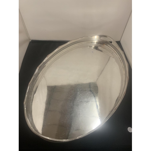 34 - A LARGE OVAL SILVER PLATE BUTLERS TRAY 61CM X 41CM