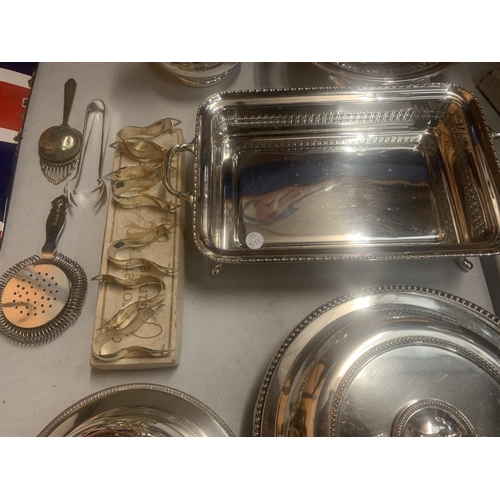 37 - A LARGE ASSORTMENT OF SILVER PLATE ITEMS TO INCLUDE A HEATED MUFFIN DISH, LEMON SQUEEZERS, A VEGETAB... 