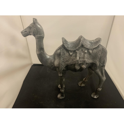 51 - A LARGE CAST METAL CAMEL AND A MIDDLE EASTERN STYLE COFFEE POT