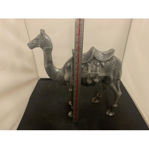 51 - A LARGE CAST METAL CAMEL AND A MIDDLE EASTERN STYLE COFFEE POT