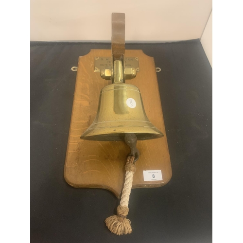 8 - A BRASS SHIPS BELL MOUNTED ON A WOODEN PLINTH TO INCLUDE AN ENGRAVED DATE  PLAQUE