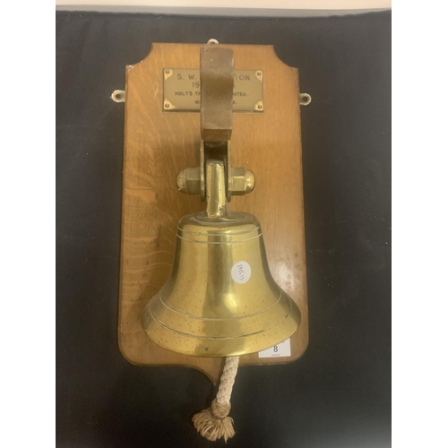 8 - A BRASS SHIPS BELL MOUNTED ON A WOODEN PLINTH TO INCLUDE AN ENGRAVED DATE  PLAQUE