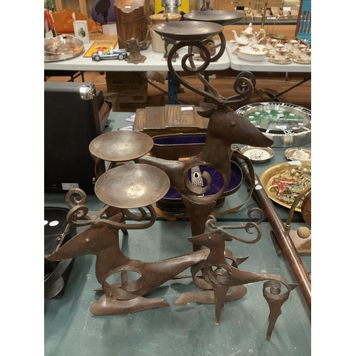 113 - THREE SCANDINAVIAN  STYLE BLACKSMITH CRAFTED REINDEER THE LARGER EXAMPLES WITH CANDLE HOLDERS ATTACH... 