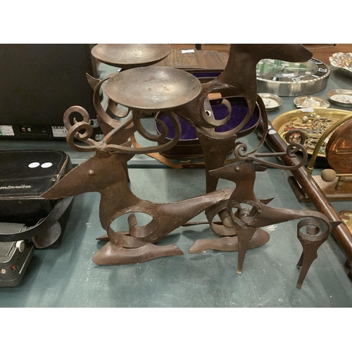 113 - THREE SCANDINAVIAN  STYLE BLACKSMITH CRAFTED REINDEER THE LARGER EXAMPLES WITH CANDLE HOLDERS ATTACH... 