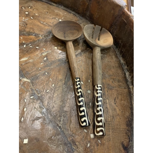 133 - A VERY LARGE HEAVILY CARVED 19TH CENTURY AFGHAN TRIBAL BOWL ON FOUR LEGS AND A PAIR OF WOODEN SERVER... 