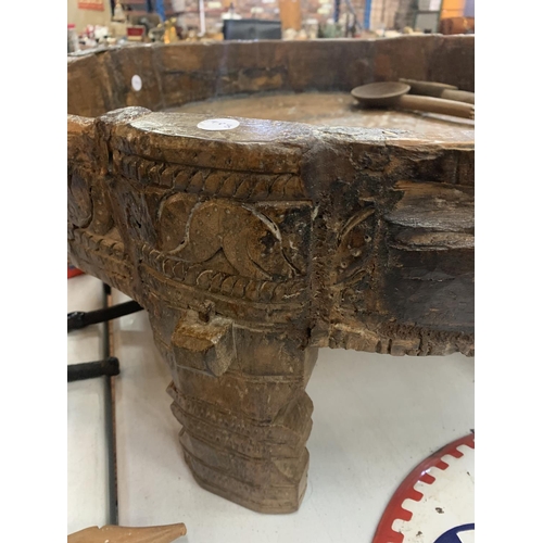 133 - A VERY LARGE HEAVILY CARVED 19TH CENTURY AFGHAN TRIBAL BOWL ON FOUR LEGS AND A PAIR OF WOODEN SERVER... 