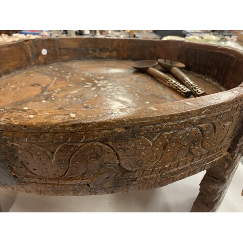 133 - A VERY LARGE HEAVILY CARVED 19TH CENTURY AFGHAN TRIBAL BOWL ON FOUR LEGS AND A PAIR OF WOODEN SERVER... 