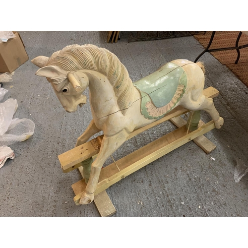 144 - A VINTAGE WOODEN CARVED ROCKING HORSE - HEIGHT TO SADDLE 65CMS