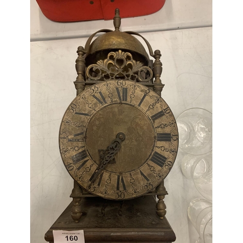 160 - A BRASS LANTERN CLOCK WITH WEIGHTS ON A WOODEN SUPPORT