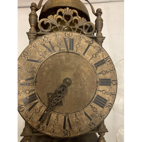 160 - A BRASS LANTERN CLOCK WITH WEIGHTS ON A WOODEN SUPPORT