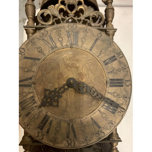 162 - A BRASS LANTERN CLOCK WITH WEIGHTS ON A WOODEN SUPPORT