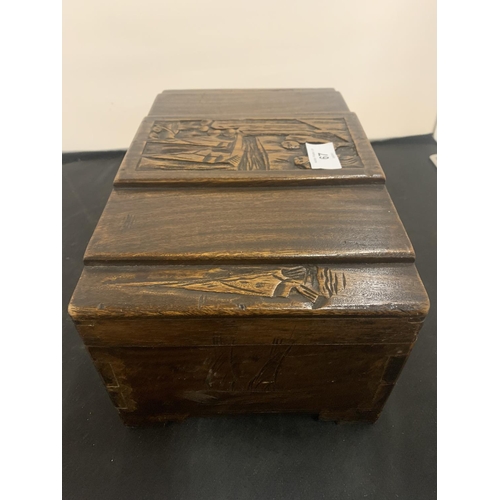 67 - A CARVED WOODEN LIDDED BOX WITH BRASS CLASP