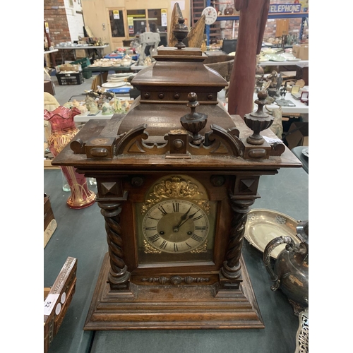 84 - A LARGE WOODEN MANTEL CLOCK (FINIALS A/F) APPROXIMATE HEIGHT 60CM