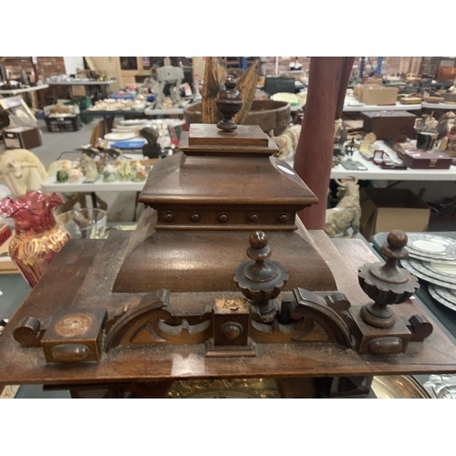 84 - A LARGE WOODEN MANTEL CLOCK (FINIALS A/F) APPROXIMATE HEIGHT 60CM