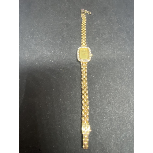 584 - A BUECHE GIROD LADIES WRIST WATCH WITH 9 CARAT GOLD CASE AND STRAP. THE WATCH HAS A SINGLE DIAMOND T... 