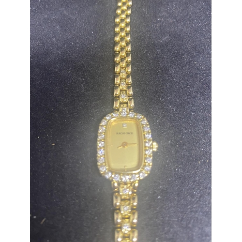 584 - A BUECHE GIROD LADIES WRIST WATCH WITH 9 CARAT GOLD CASE AND STRAP. THE WATCH HAS A SINGLE DIAMOND T... 