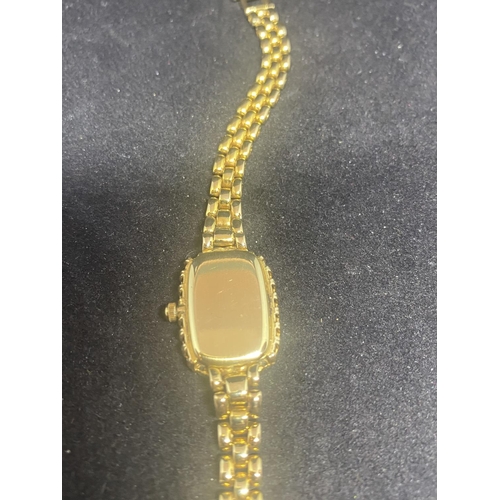 584 - A BUECHE GIROD LADIES WRIST WATCH WITH 9 CARAT GOLD CASE AND STRAP. THE WATCH HAS A SINGLE DIAMOND T... 