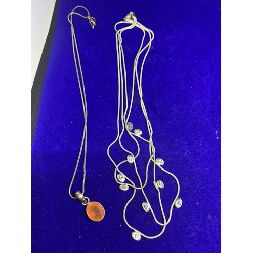 609 - FOUR SILVER NECKLACES MARKED 925 WITH PENDANTS TO INCLUDE AN ORANGE STONE, A SQUARE, AND A CLEAR STO... 