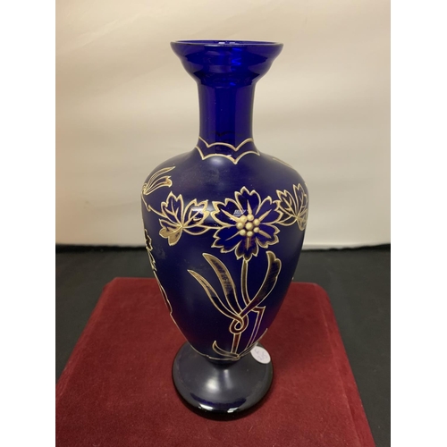 749 - A BLUE GLASS URN WITH GOLD RELIEF FLOWER PATTERN (HEIGHT 26CM)