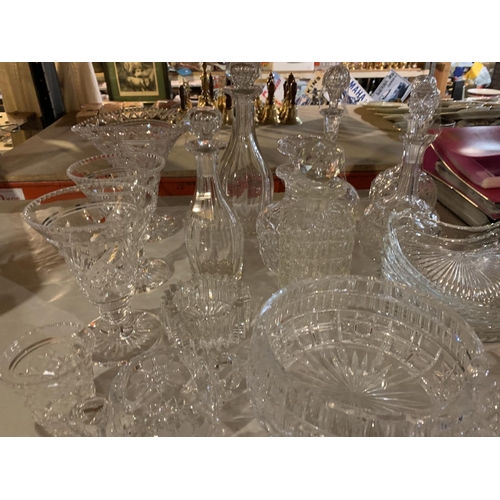 932 - A VARIETY OF CUT GLASS WARE TO INCLUDE DECANTERS, VASES AND GLASSES ETC