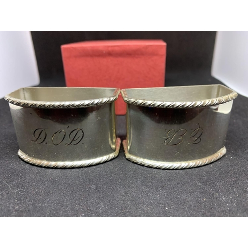 601 - A PAIR OF NAPKIN RINGS MARKED 925 IN AN OMEGA BOX