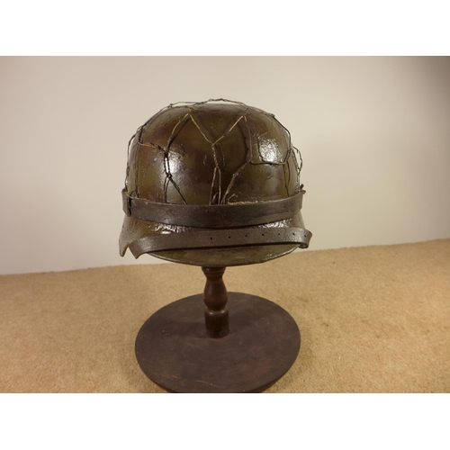 384 - A GERMAN WORLD WAR II PERIOD STEEL HELMET WITH LEATHER LINER, LATER PAINT