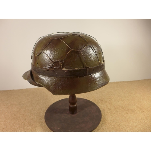 384 - A GERMAN WORLD WAR II PERIOD STEEL HELMET WITH LEATHER LINER, LATER PAINT