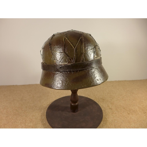 384 - A GERMAN WORLD WAR II PERIOD STEEL HELMET WITH LEATHER LINER, LATER PAINT