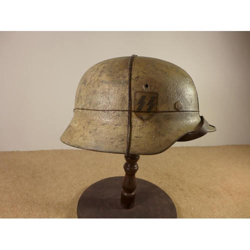 385 - A GERMAN WORLD WAR II PERIOD STEEL HELMET WITH LEATHER LINER, LATER PAINT