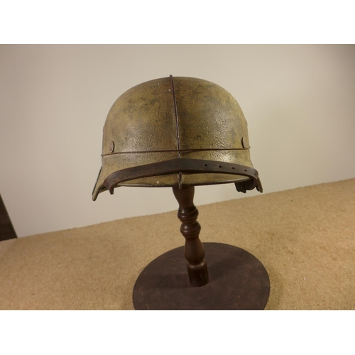 385 - A GERMAN WORLD WAR II PERIOD STEEL HELMET WITH LEATHER LINER, LATER PAINT