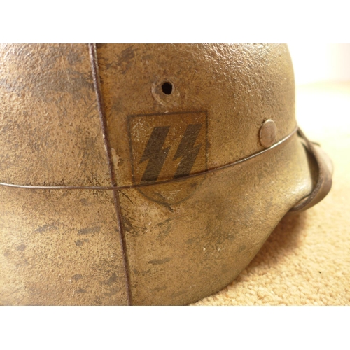 385 - A GERMAN WORLD WAR II PERIOD STEEL HELMET WITH LEATHER LINER, LATER PAINT