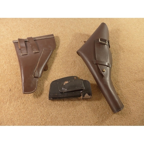 396 - A BLACK LEATHER WALTHER PP BELT HOLSTER AND TWO FURTHER BROWN LEATHER HOLSTERS (3)