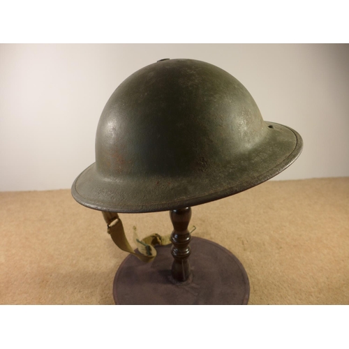 401 - A GREEN PAINTED BRITISH STEELHELMET AND LINER