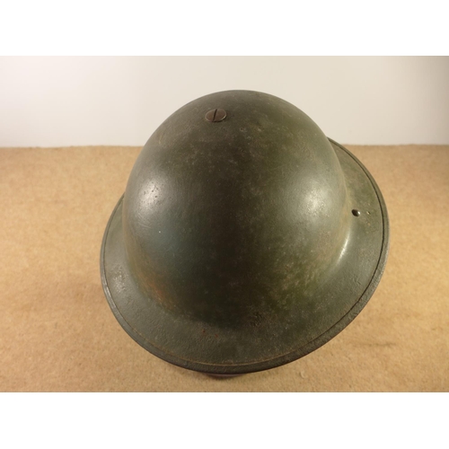 401 - A GREEN PAINTED BRITISH STEELHELMET AND LINER