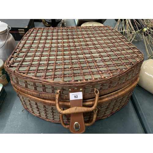 101 - A LARGE WICKER PICNIC BASKET CONTAINING PLATES, CUPS AND CUTLERY FOR FOUR PEOPLE